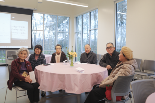 Church members posing at their table for 이옥순 birthday party