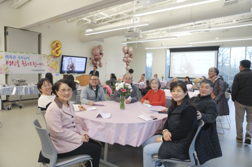Church members posing at their table for 이옥순 birthday party