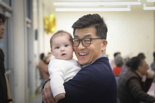 Dr. Lee posing with grandchild